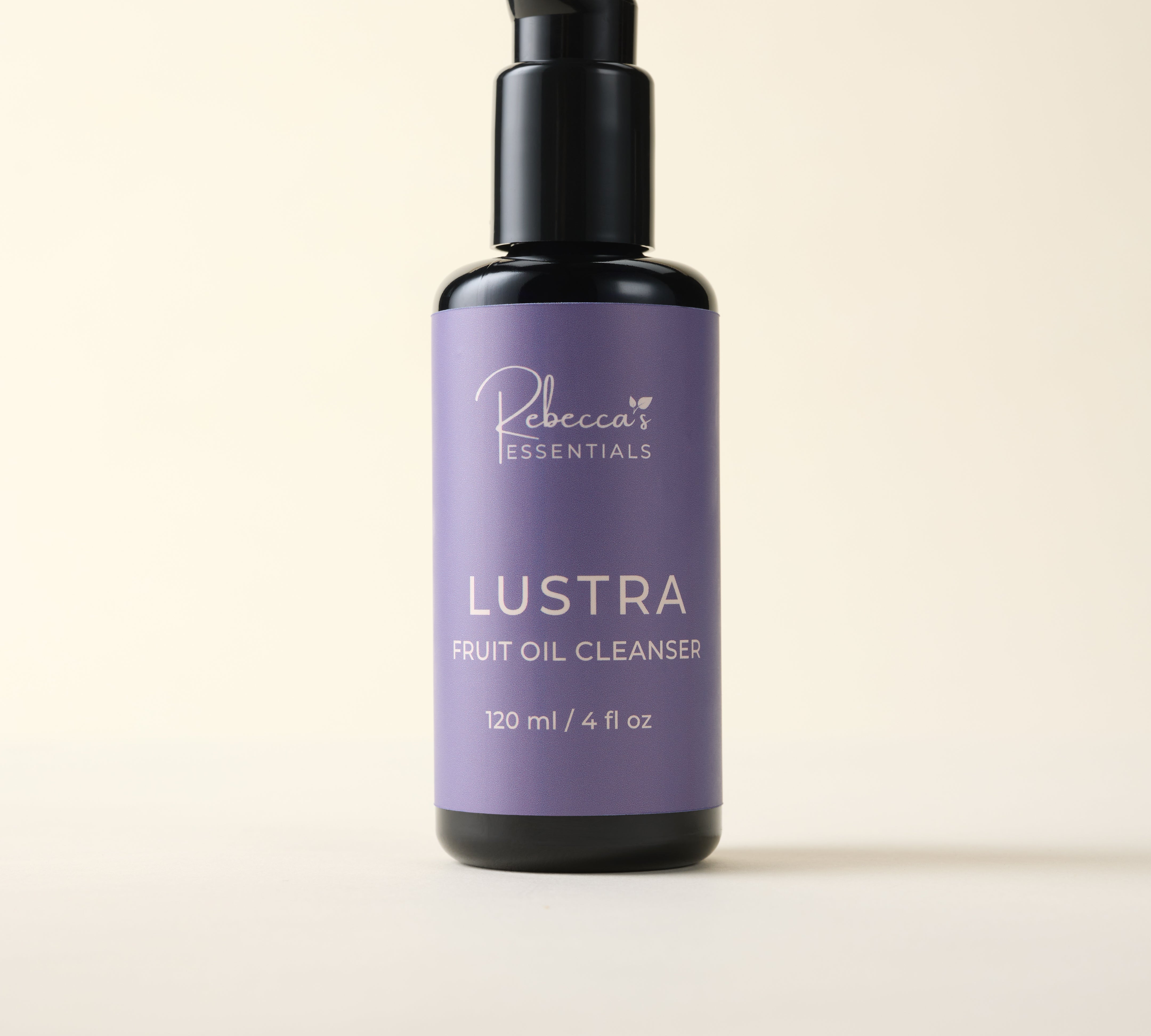 Lustra fruit oil cleanser bottle with purple label on a beige background