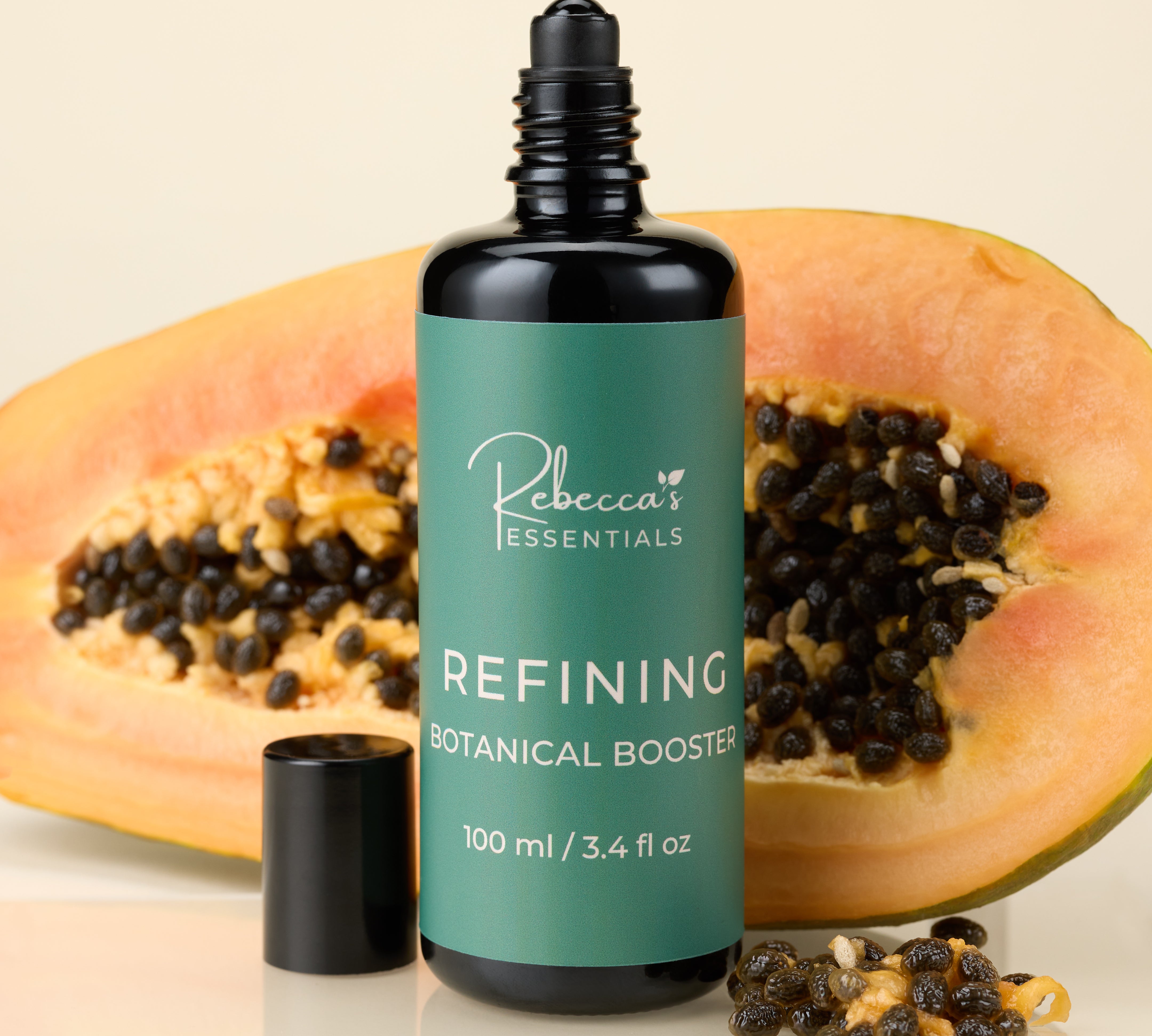 Bottle of Rebecca's Essentials Refining Botanical Booster with a halved papaya on a beige background