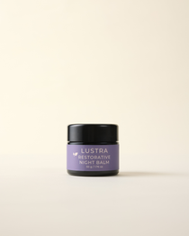 Lustra Restorative Night Balm jar on a beige background