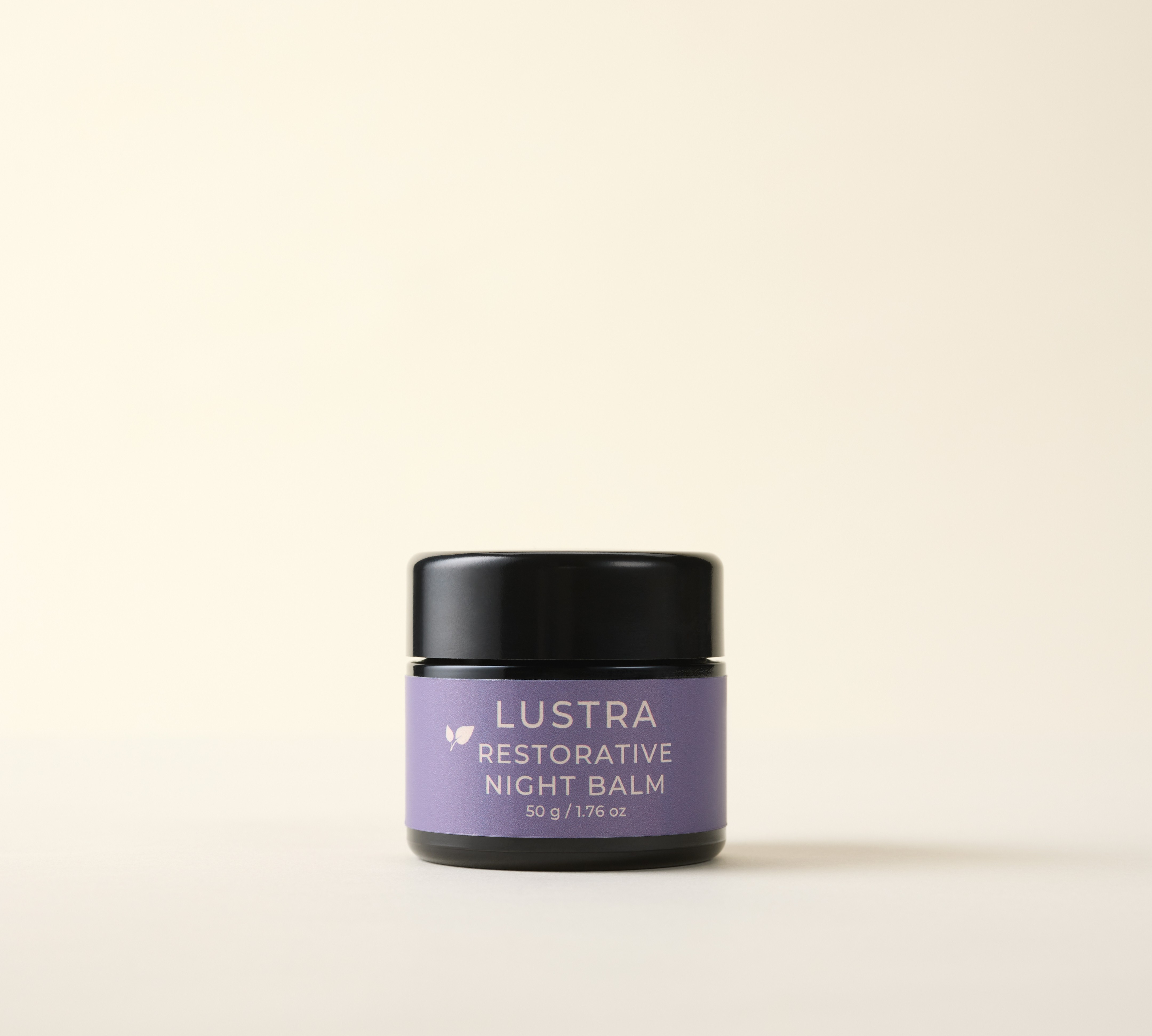Lustra Restorative Night Balm jar on a beige background