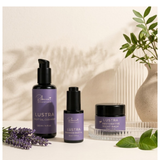 The Essential Trio — cleanser, face oil, and night balm arranged on a light beige surface with soft shadows.